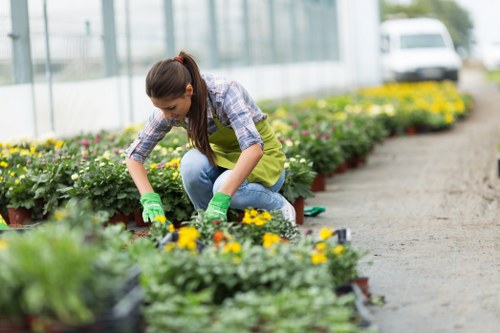Team leader with safety paperwork at a garden entrance