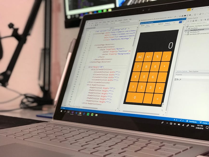 A close-up view of a laptop displaying a coding script on the left side of the screen, with visible HTML and CSS code concerning styling elements like width, height, and background colour. The right s